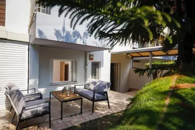 a patio with two chairs and a table at Pame Rentals - Cozy Glyfada Stay with Free Parking in Athens