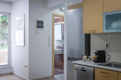 a kitchen with a sink and a counter top at Pame Rentals - Cozy Glyfada Stay with Free Parking in Athens