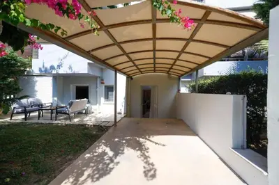 a patio with awning and a table and chairs at Pame Rentals - Cozy Glyfada Stay with Free Parking in Athens