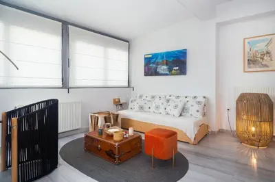 a bedroom with a bed and a table in it at The Parthenon View in the Historical Center! in Athens
