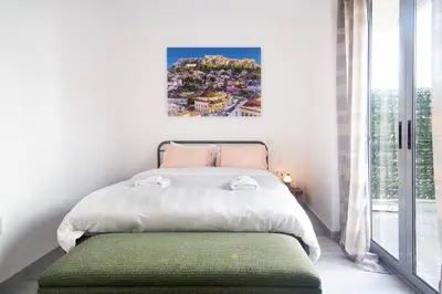 a bedroom with a bed and a large window at The Parthenon View in the Historical Center! in Athens
