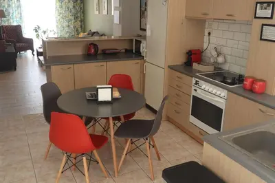 a kitchen with a table and red chairs in a kitchen at Apartment_41 in Athens