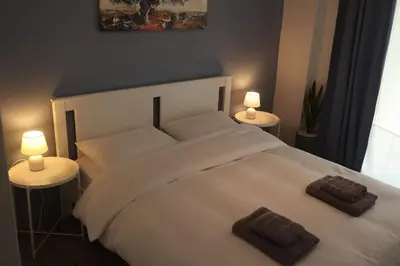 a bedroom with a white bed with two pillows on it at Apartment_41 in Athens