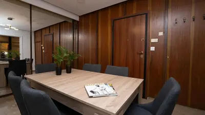 a conference room with a wooden table and chairs at Quiet City Center Apt on a Pedestrian Street in Athens
