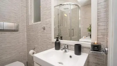 a bathroom with a sink and a mirror at Quiet City Center Apt on a Pedestrian Street in Athens