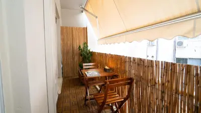 a row of tables and chairs in a restaurant at Quiet City Center Apt on a Pedestrian Street in Athens