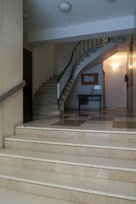 a set of stairs in a building with a table at Quiet City Center Apt on a Pedestrian Street in Athens
