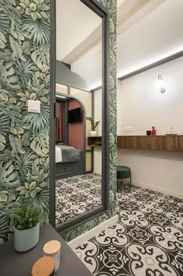 a mirror on a wall in a room at Athens Luxury Rooms II in Athens