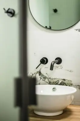 a bathroom with a white sink and a mirror at Athens Luxury Rooms I in Athens