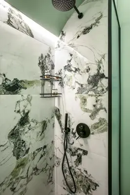 a shower with a black and white marble wall at Athens Luxury Rooms I in Athens