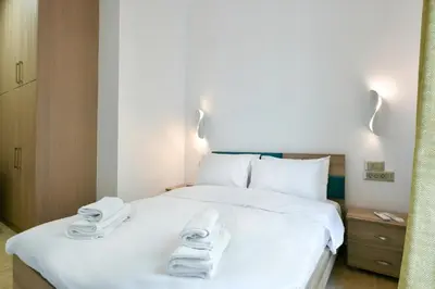 a bedroom with a white bed with towels on it at 2bedroom Renovated Apartment in Athens