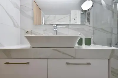 a white bathroom with a sink and a mirror at 2bedroom Renovated Apartment in Athens