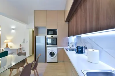 a kitchen with a washer and dryer next to a counter at 2bedroom Renovated Apartment in Athens