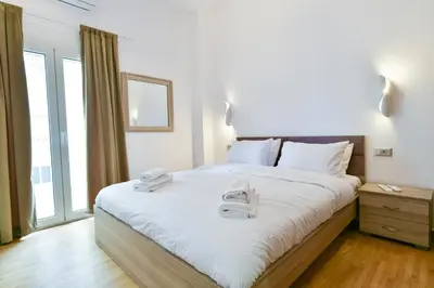 a bedroom with a large bed with towels on it at 2bedroom Renovated Apartment in Athens