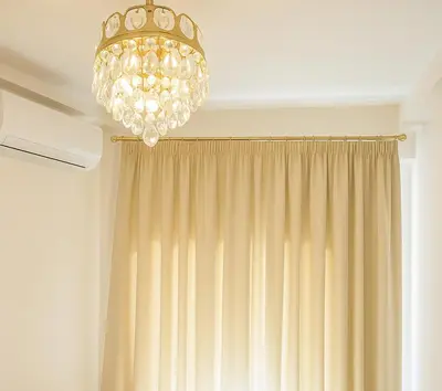 a chandelier hanging from a ceiling next to a curtain at Metropolis B2 -Γοητευτική Σουίτα in Athens