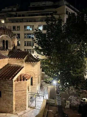 a building with a tree in front of a building at Metropolis B2 -Γοητευτική Σουίτα in Athens