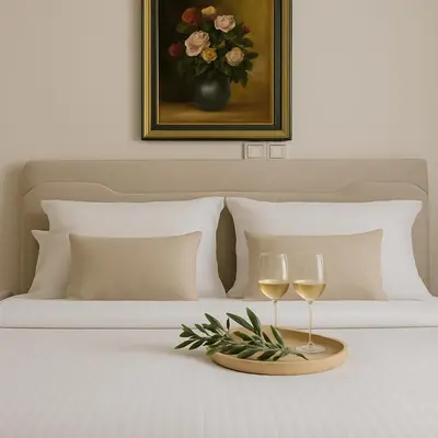 a bed with two glasses of wine on a tray at Metropolis B2 -Γοητευτική Σουίτα in Athens