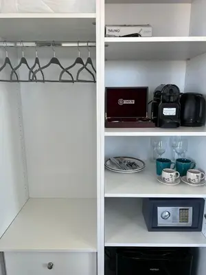 a white pantry with a toaster and some cups and plates at Majestic Penthouse Acropolis in Athens