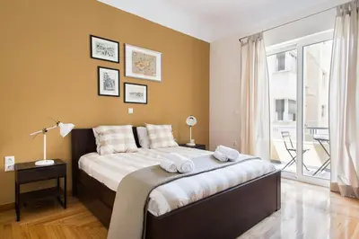 a bedroom with a large bed with towels on it at Athena's Nest- *best Location* A/C +HEAT! in Athens