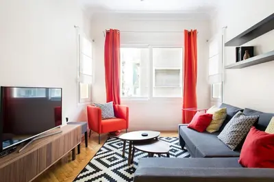 a living room with a couch and a tv at Athena's Nest- *best Location* A/C +HEAT! in Athens