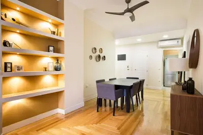 a dining room with a black table and chairs at Athena's Nest- *best Location* A/C +HEAT! in Athens