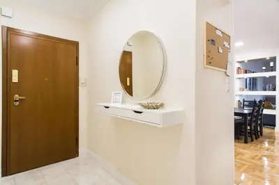 a hallway with a door and a mirror on a wall at Athena’s Hideaway- Fully Renovated- Absolute Best Location in Athens