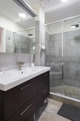 a bathroom with a sink and a shower at Athena’s Hideaway- Fully Renovated- Absolute Best Location in Athens