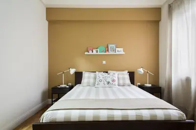 a bedroom with a large bed with two lamps at Athena’s Hideaway- Fully Renovated- Absolute Best Location in Athens