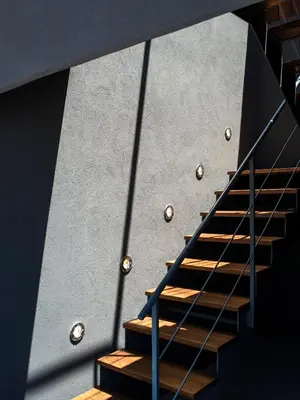 a staircase with wooden treads and a gray wall at Periscope in Athens