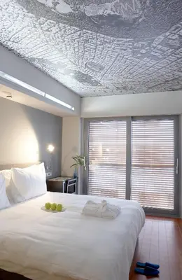 a bedroom with a large white bed with fruit on it at Periscope in Athens