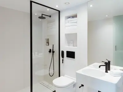 a bathroom with a shower and a toilet and a sink at Periscope in Athens