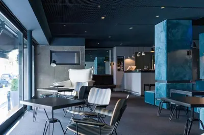a restaurant with tables and chairs and a kitchen at Periscope in Athens