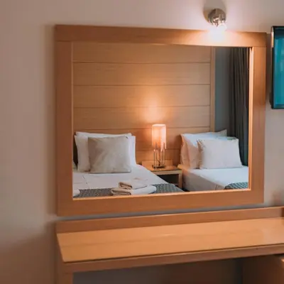 a mirror in a hotel room with two beds at Parnon Hotel in Athens