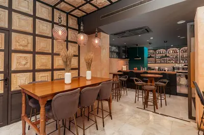 a restaurant with a wooden table and chairs at Parnon Hotel in Athens