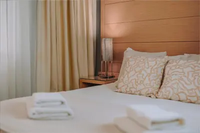 a hotel room with a bed with two white towels at Parnon Hotel in Athens