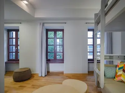 a room with a bunk bed and a table at A Neoclassical Mansion in Athens in Athens