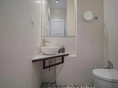 a white bathroom with a sink and a toilet at A Neoclassical Mansion in Athens in Athens