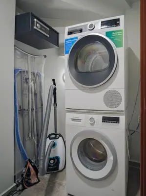 a washing machine and a dryer in a room at A Neoclassical Mansion in Athens in Athens
