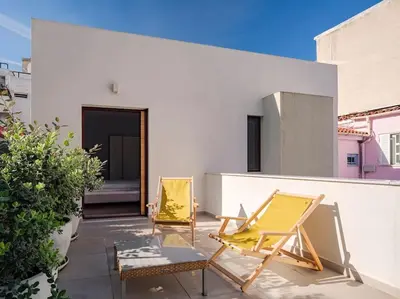 two chairs and a table on a patio at A Neoclassical Mansion in Athens in Athens