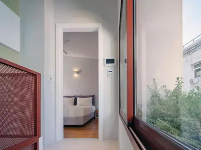 a hallway with a room with a couch and a window at A Neoclassical Mansion in Athens in Athens