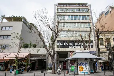 a building on a street with people walking in front of it at Acropolis Breathtaking View in Athens