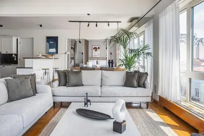 a living room with two couches and a kitchen at Acropolis Breathtaking View in Athens