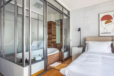 a bedroom with a bed and a bath tub in a room at Acropolis Breathtaking View in Athens