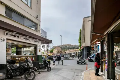 a group of people walking down a city street at Acropolis Breathtaking View in Athens