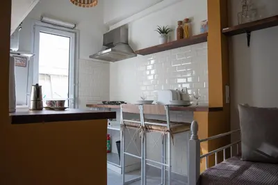 a small kitchen with a counter and a sink at 3C's-Central, Cosy, Convenient to Airport 24/7 in Athens