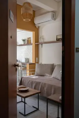 a bedroom with a bed and a table in a room at 3C's-Central, Cosy, Convenient to Airport 24/7 in Athens