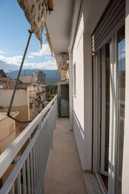 a balcony of a building with a view of the ocean at 3C's-Central, Cosy, Convenient to Airport 24/7 in Athens