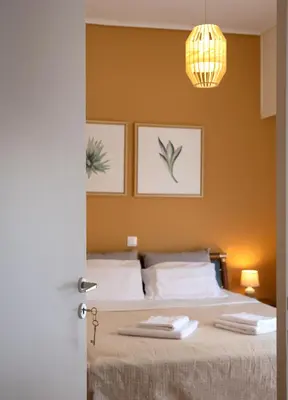 a bedroom with a bed with two towels on it at 3C's-Central, Cosy, Convenient to Airport 24/7 in Athens