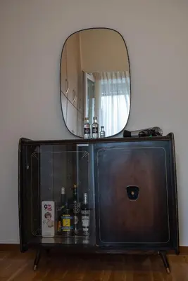 a mirror on top of a dresser in a room at 3C's-Central, Cosy, Convenient to Airport 24/7 in Athens