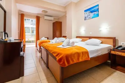 a hotel room with two beds and a television at Faros I in Piraeus